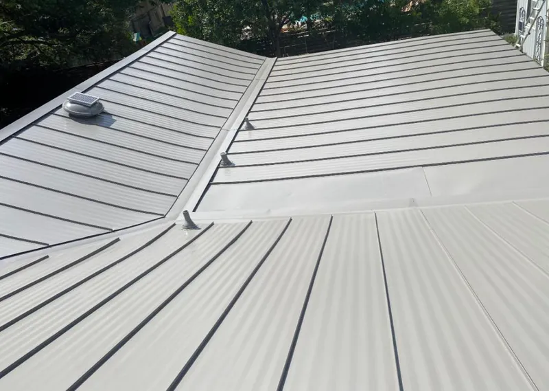 Solar attic fan installed on a metal roof for Roof Ventilation in Egelston
